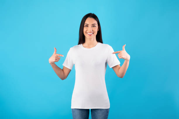 Happy young woman pointing fingers at herself