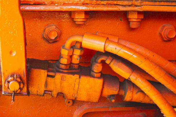 Closeup of hydraulic fittings and hoses on a large truck.