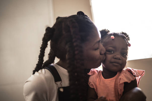 istock Siblings embracing at home 1227013006