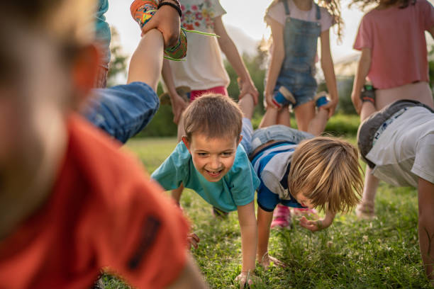 istock Wheelbarrow race in public park 1227013236