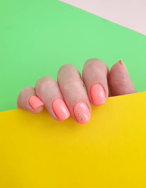 istock female hand beautiful manicure on a colored background 1227013997