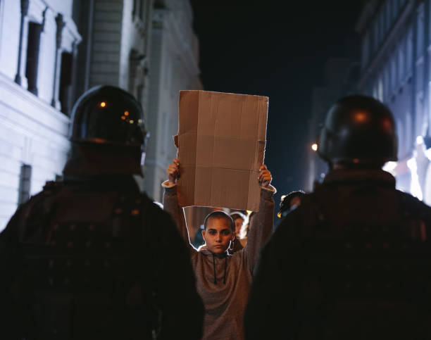 istock Demonstrators protesting in front of policemen 1227014046