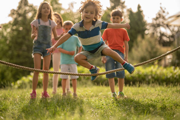 Playful boy is skipping jump rope