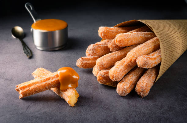 Traditional Churros with sugar and dulce de leche stock photo