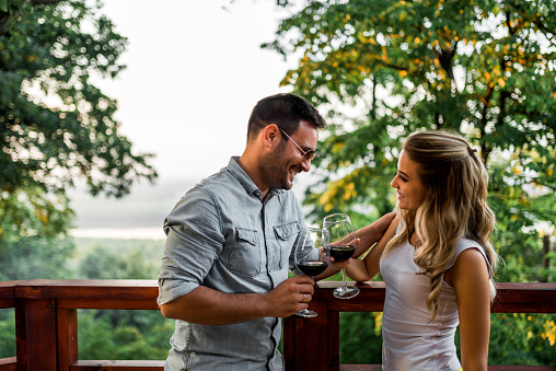 Couple enjoying glass of wine outdoors.