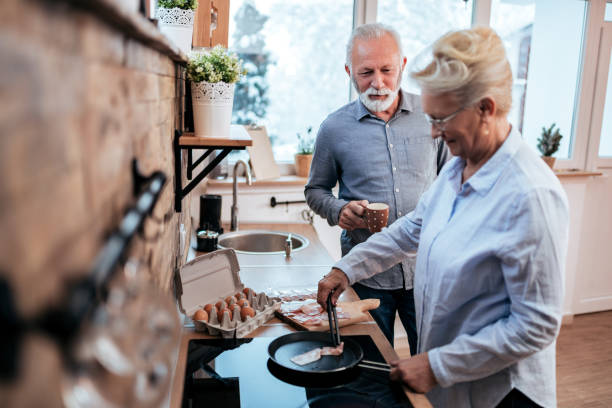 istock Senior couple preparing breakfast in the kitchen. 1227015884