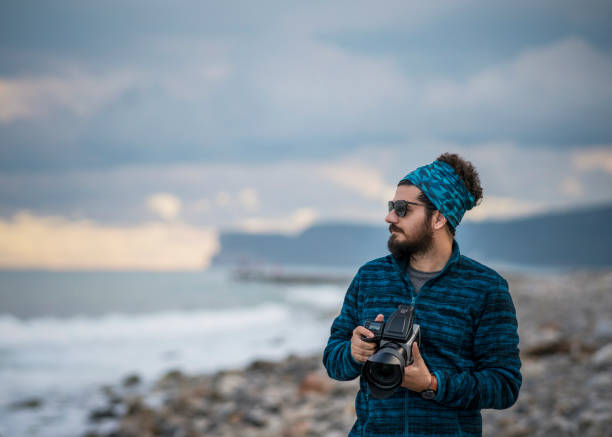 An adventure photographer sightseeing in Khobar sea side sunrise background. City : Khobar/ Saudi Arabia.