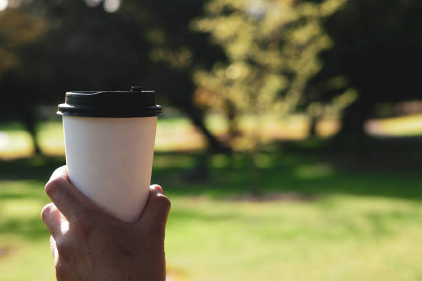 istock biodegradable paper cup on trees and green background. eco friendly and sustainability concept. 1227018575