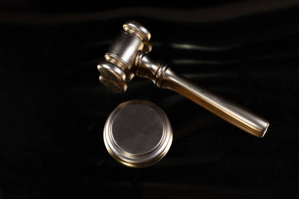 istock golden law hammer isolated on black background 1227018579