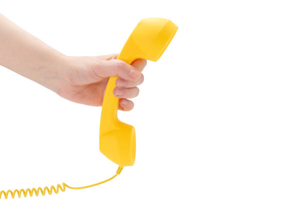 istock Yellow handset in woman hand isolated on white. 1227019207