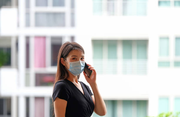 single female wearing mask during covid 19 single female wearing mask during covid 19 telephone voip dust internet stock pictures, royalty-free photos & images