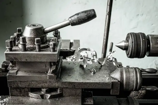 Photo of knobs and screws on old lathe in ironworks factory