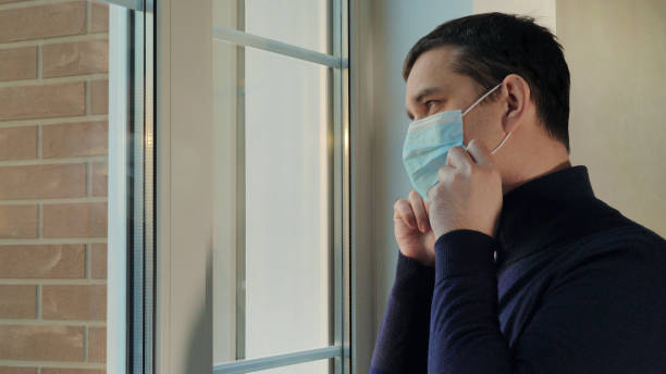 istock Man puts on a medical mask 1227021903