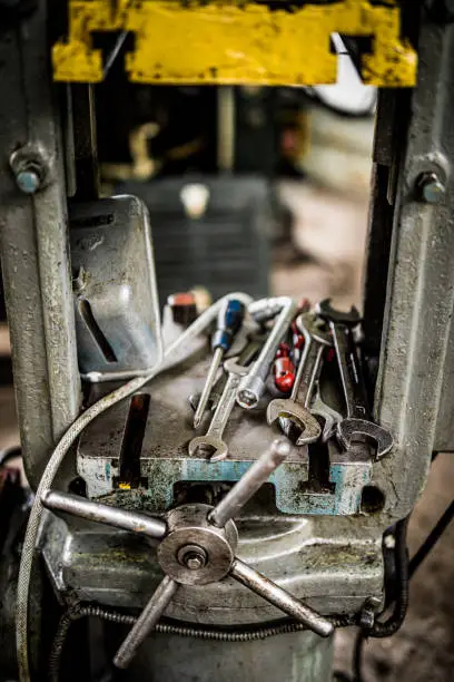 Photo of dirty tools in ironworks factory on the machine