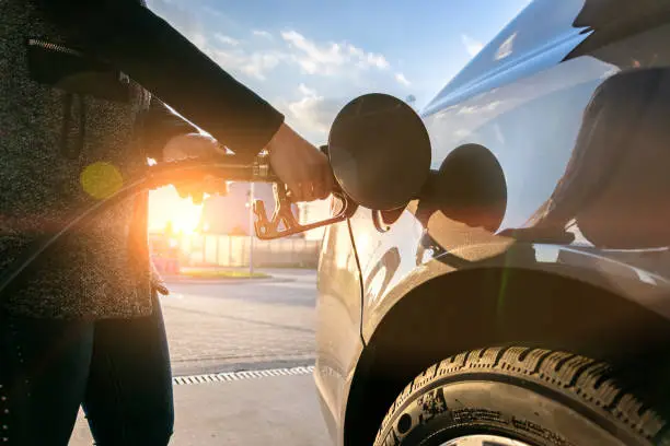 Refueling car. Pump gas at petrol fuel station. Gasoline oil nozzle tank from hand person. Automotive industry or transportation concept