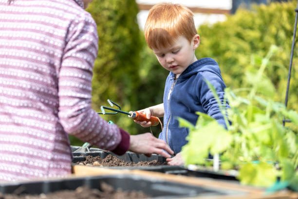 istock Cute Kid and Mother Gardening While Quarantined at Home During Springtime 1227025542