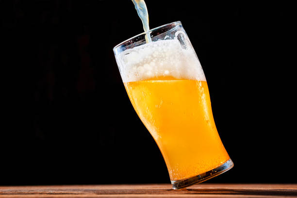 istock Beer pouring into a glass on the dark background 1227026468