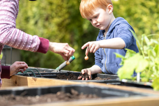 istock Cute Kid and Mother Gardening While Quarantined at Home During Springtime 1227026497