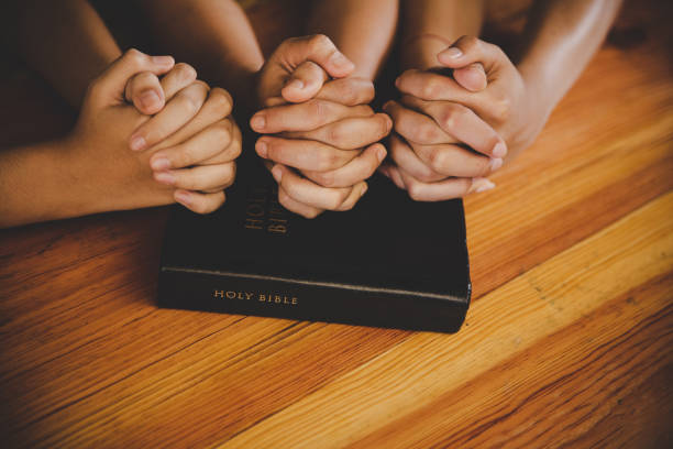 istock Family pray together praying with parent at home 1227027770