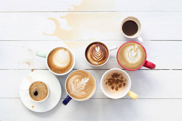 istock Many cups of coffee on white wood table. Top view space for text 1227028161