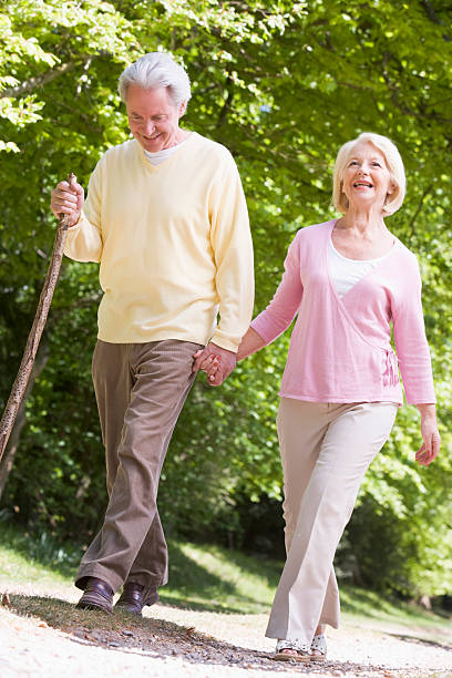 istock Couple walking along path in park holding hands 122702841