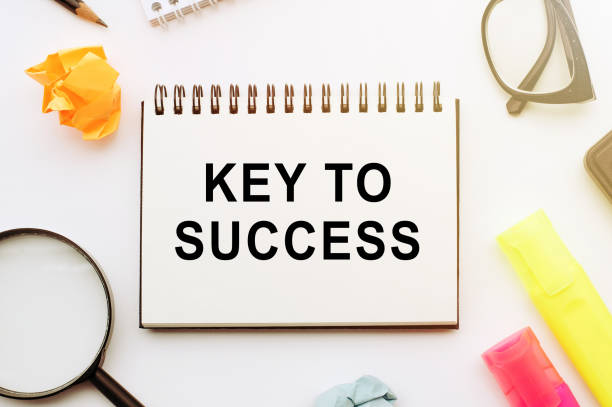 istock The text, the word Key To Success, is written in a notebook lying on white table with a pen, glasses and magnifier. Business concept 1227029201