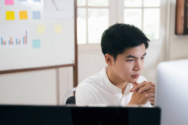 istock Young businessman analyze online marketing in his computer 1227029230