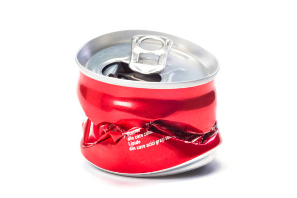 istock A red empty broken aluminum can at the white background, a close up. 1227029494