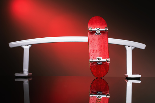 White metal railing and red fingerboard, close-up