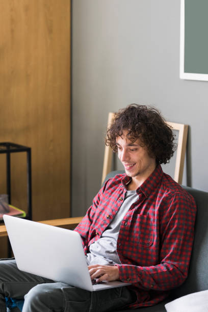 istock Learning and Studying from Home: a College Student Attending an Online Course by Using his Laptop Computer 1227031547