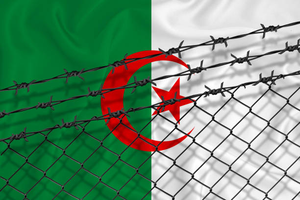 istock Developing Argentina Flag, mesh fence and barbed wire. Concept of isolation of emigrants. With place for your text. 1227032646