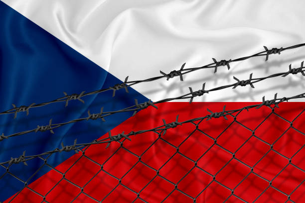 istock Developing Czech Flag, mesh fence and barbed wire. Concept of isolation of emigrants. With place for your text. 1227032666