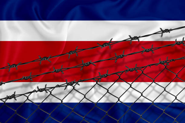 istock Developing Thailand Flag, mesh fence and barbed wire. Concept of isolation of emigrants. With place for your text. 1227032974
