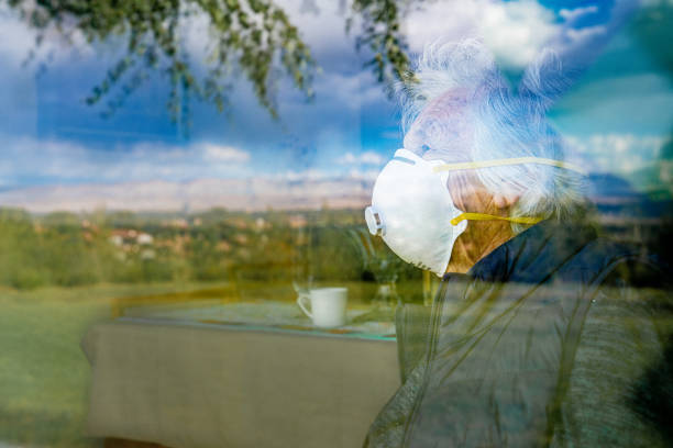 Free Stock Photo of Caucasian senior woman wearing a mask, looking out ...