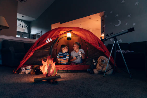 istock Boy and Girl Camping Indoors 1227034940