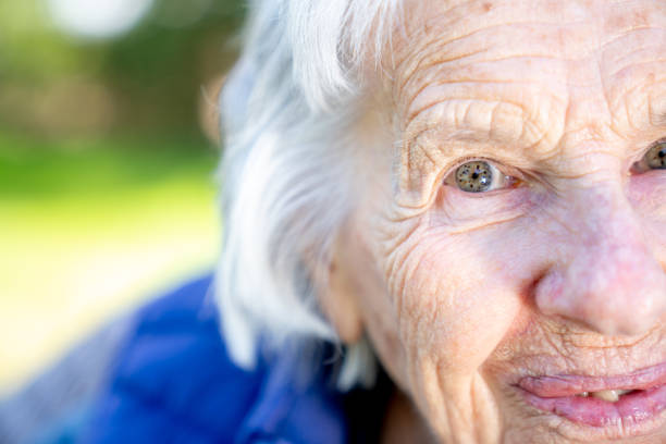 istock Beautiful, Sharp, Intelligent Elderly Senior Caucasian Woman's Unique Speckled Pretty Eyes and Face in the Summer Outdoors 1227036106
