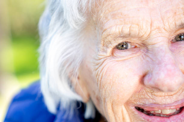 istock Beautiful, Sharp, Intelligent Elderly Senior Caucasian Woman's Unique Speckled Pretty Eyes and Face in the Summer Outdoors 1227036109