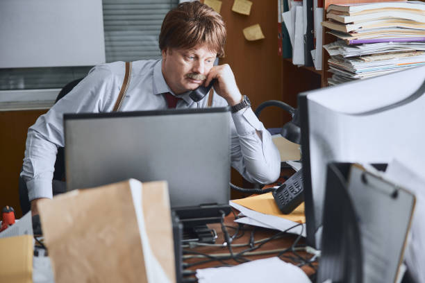 istock Adult corporate worker talking on fixed-line phone 1227036210