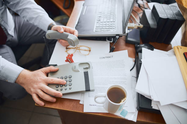 istock Unknown businessman preparing to communicate by landline phone 1227036233