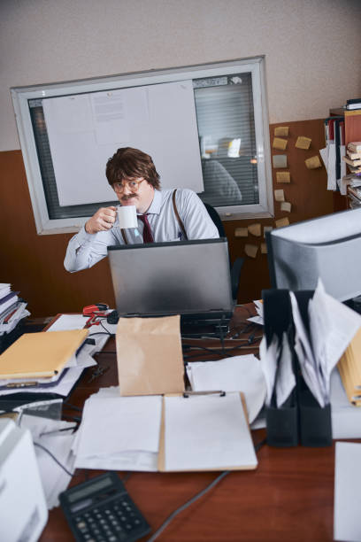 istock Adult man drinking tea at the table in his office 1227036246