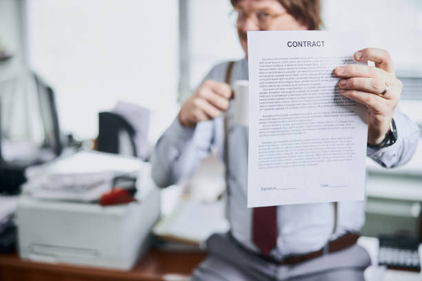 istock Paper document in hand of a middle-aged businessman 1227036255