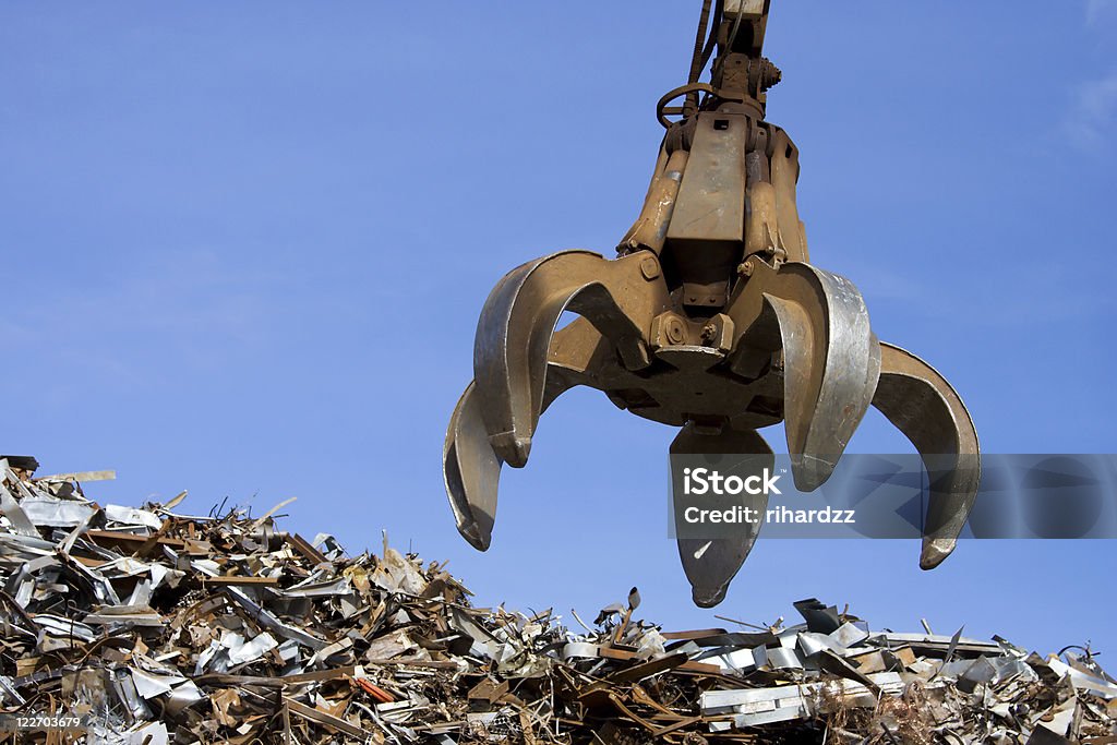 crane grabber up on the metal  heap  Scrap Metal Stock Photo