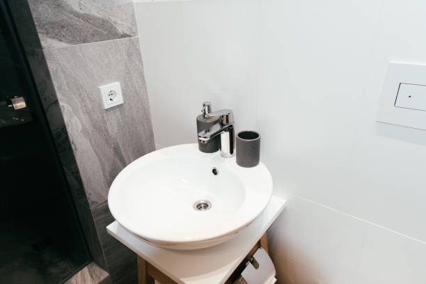 istock modern interior of bathroom with white washbasin and soap dispenser 1227040126