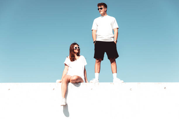 istock Young Couple On Modern Concrete Wall Urban Lifestyle 1227040826