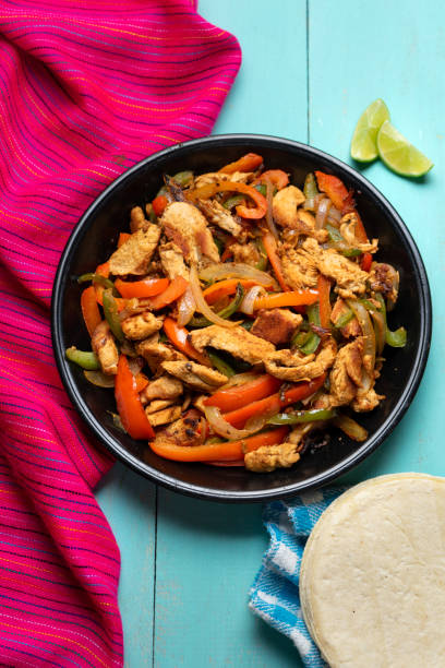 istock Mexican chicken fajitas on turquoise background 1227040917