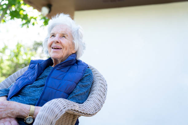 beautiful 90 plus year-old elderly senior caucasian woman sitting outdoors in the summer - 80 year old imagens e fotografias de stock