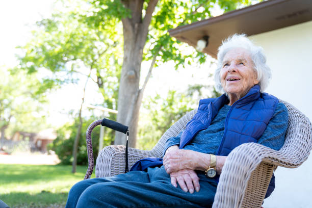 beautiful 90 plus year-old elderly senior caucasian woman sitting outdoors in the summer - 80 year old imagens e fotografias de stock