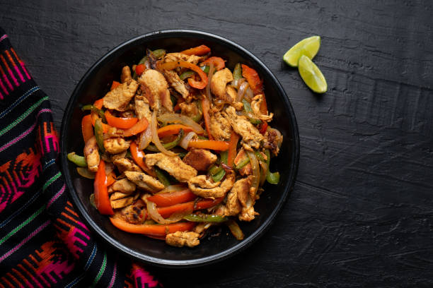 istock Mexican chicken fajitas on dark background 1227041861