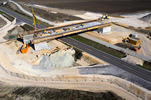 Construction of a highway bridge over the road, aerial view.