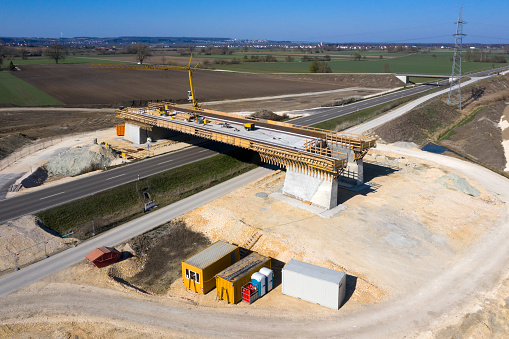 Construction of a highway bridge over the road, aerial view.